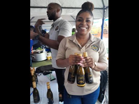 Credit: Paul H Williams Smith’s Rum Cream’s Sherane Palmer displaying three flavours, including coffee, at last Saturday’s coffee festival at Newcastle in St Andrew.