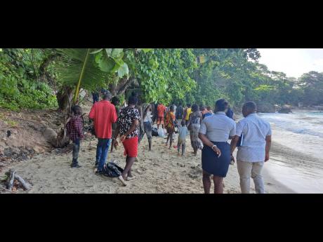 Haitians exiting  Boston Beach in Portland, under the supervision of the police, en route to the Port Antonio Health Centre to undergo screening.
