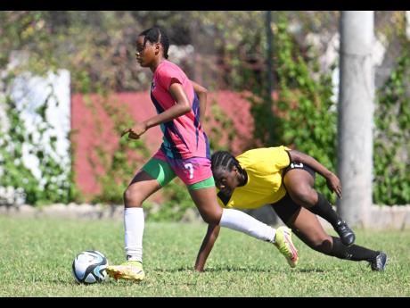 Credit: Gladstone Taylor
Frazsiers Whip FC’s Destiny Powell (left) leaves Cavalier’s Jada Blanchette struggling for balance during their Jamaica Women’s Premier League fixture at the Alpha Institute yesterday.