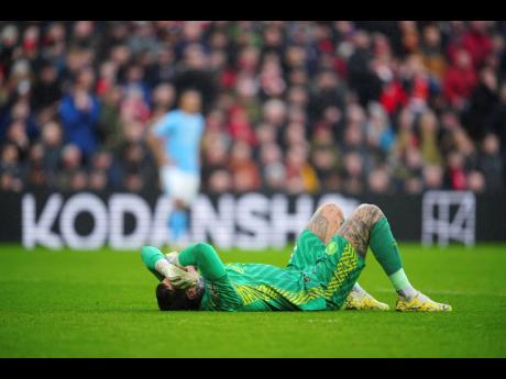 Credit: AP Manchester City’s Brazilian goalkeeper Ederson lies on the ground after an injury during the English Premier League match between Liverpool and Manchester City, at Anfield stadium in Liverpool, England on Sunday.