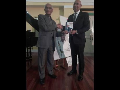 Carlton Davis presents a copy of his book, ‘My Life’, to Governor General Sir Patrick Allen.