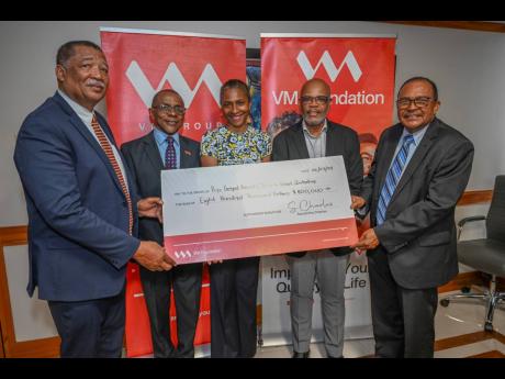 From left: Rev Samuel McCook, chairman, National Leadership Prayer Breakfast (NLPB) committee; Courtney Campbell, group president and CEO, VM Group; and Samantha Charles, CEO, VM Foundation hand over a symbolic cheque valued at $800,000 to the Hope Gospel 