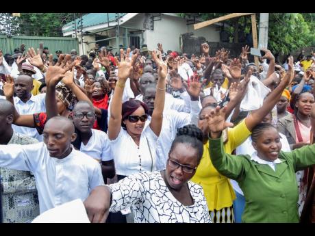 Supporters of Pastor Ezekiel Odero, who was arrested last week in connection to the deaths of dozens of his congregants and is also being investigated for links to controversial Pastor Paul Mackenzie, pray for his release outside a law court in the coastal
