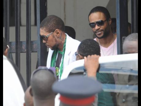 Credit: File Entertainers Vybz Kartel and Shawn Storm leave the Home Circuit court where they were sentenced to life imprisonment on Thursday, April 3, 2014.
