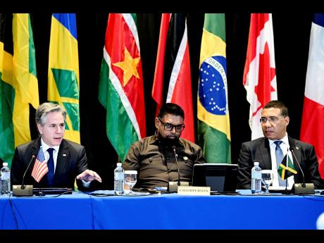 Jamaica’s Prime Minister Andrew Holness and Dr. Mohamed Irfaan Ali, President of the Cooperative Republic of Guyana and Chairman of the Conference of CARICOM Heads of Government listening as US Secretary of State Antony Blinken makes an announcement duri