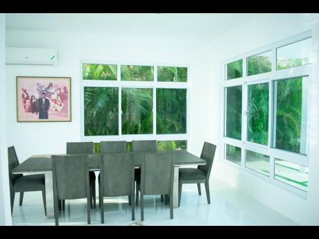 The dining area is very much a part of the tropical outdoors, thanks to the glass openings.