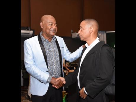 Michael Ricketts (left), Jamaica Football Federation president, with General Secretary Dennis Chung at the Royalton Resort in  Negril yesterday after Ricketts was re-elected President of the JFF. 