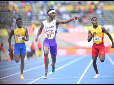 Kingston College’s Tahj-Marques White (centre) wins the Class Two 200 metres final at last year’s ISSA/GraceKennedy Boys and Girls’ Athletics Championships.