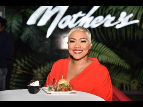 The beautiful host of the grand opening, Debbie Bissoon, shares a radiant smile before indulging in the event’s festivities.