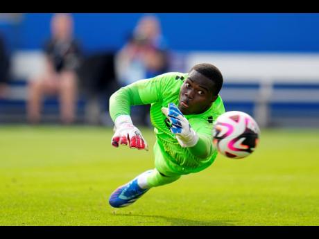 Trinidad and Tobago goalkeeper Denzil Smith makes a diving attempt on a Canadian shot in the second half of a Concacaf Nations League Play-In football match yesterday.