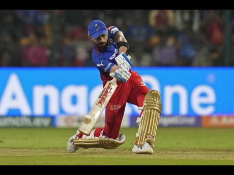 Credit: AP Royal Challengers Bengaluru’s Virat Kohli in action against Punjab Kings in the Indian Premier League yesterday.