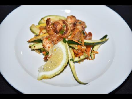 Credit: Antoine Lodge Flambéed pepper shrimp, prepared on the spot, was one of the night’s hits.