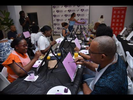 Attendees followed the step-by-step instructions provided for the evening’s butterfly artwork, led by Island Strokes.