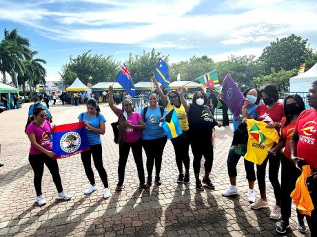Members of the Regional Health Communication Network show off their country flags during the launch of Caribbean Moves, staged in Kingston, Jamaica, in September 2022.