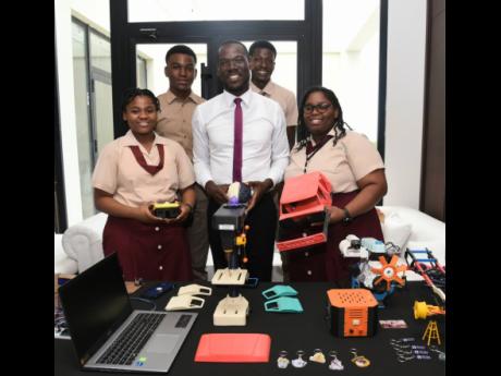 Credit: Ashley Anguin Herbert Morrison Technical High engineering club’s (back row, left to right): Ryan Gooden, Javey Heaven, (front row, left to right) Prudent Salmon, Kevin Coke, mechanical technology teacher, and Kayla Hewan pose for The Gleaner on Day Two yesterday durin