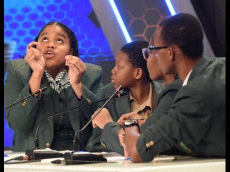St Jago High captain Jhaneille Esson tackles a question while her teammates look on during Thursday night’s final.