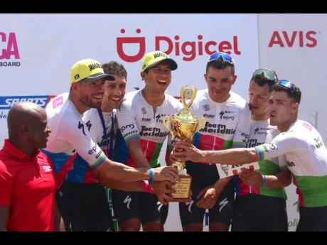 Wilmar Paredes (second right) poses with his Medellin teammates after claiming the top spot at the Jamaica International Cycling Classic in Montego Bay yesterday. Looking on at left is Elon Parkinson of sponsors Digicel.