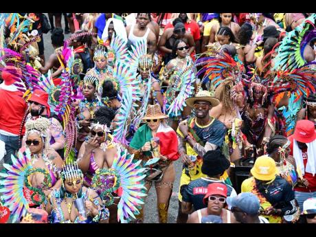 GenXs revellers on Worthington Avenue as they await the passing of the Xodus and Bacchanal and Yard Mas bands.GenXs revellers on Worthington Avenue as they await the passing of the Xodus and Bacchanal and Yard Mas bands.