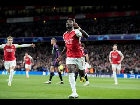 Arsenal’s Bukayo Saka celebrates after scoring the opening goal during the Champions League quarter final first leg football match against Bayern Munich at the Emirates Stadium, London yesterday.