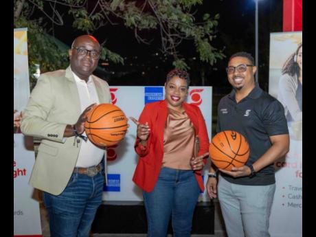 From left: Exceptional Maintenance Limited’s Managing Director Sheldon Jackson and General Manager Jullian Carter pose for a snapshot with Scotiabank’s Shamair Bramwell.