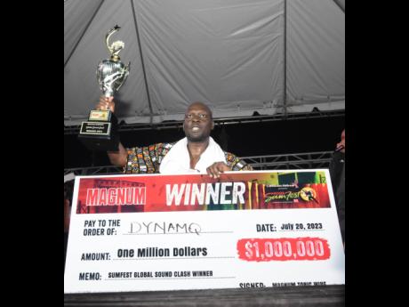 Dynamq proudly hoists the Reggae Sumfest Global Sound Clash trophy after claiming the 2023 global sound clash title and winning $1 million dollars inside the Pier One car park in Montego Bay.