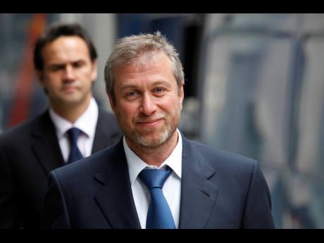 
In this file photo, former owner of England’s Chelsea Football Club, Russian tycoon Roman Abramovich, as he leaves court in London on October 4, 2011. 