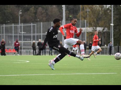 
Kingston Football Academy under-15 captain Jaeden Morgan (left) strikes the ball ahead of a PSV Eindhoven player during a game from the club’s tour of the Netherlands. 
