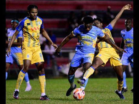 
Harbour FC’s Casseam Priestley (left) looks on as Waterhouse’s Nickoy Christian (centre) competes with teammate Trey Bennett for possession during a Jamaica Premier League fixture at the Anthony Spaulding Sports Complex in January. 