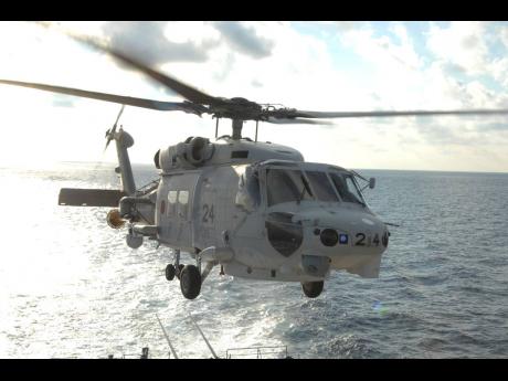 This undated photo released by and taken from the official website of the Japan Maritime Self-Defense Force, shows a SH-60K chopper.
