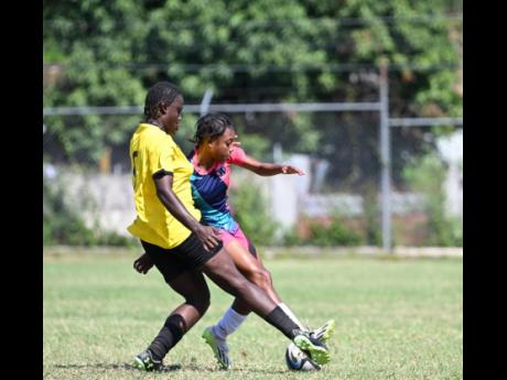 Frazsiers Whip's Shanel Buckley (background) fights for possession of the ball with Cavalier's Ashanti Lewis during a recent Jamaica Women's Premier League football encounter at Alpha Institute.