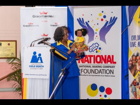 Dr Pauline Mullings speaking to her Island Dolls mascot, which she has been using over the years to help create awareness while engaging the children. 