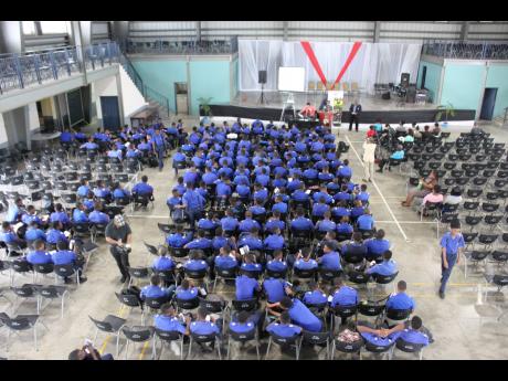 In this 2018 photo third form students of Jamaica College listen to a presentation at Karl Hendrickson Auditorium
