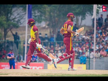 West Indies ‘A’ batsmen Roston Chase (right) and Keacy Carty jog a single during the opening game of their T20 cricket match against Nepal at the Tribhuvan University International Cricket Ground yesterday.
