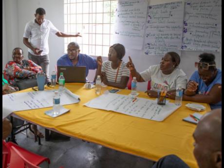 Santane Little Foster (second right), a teacher and entrepreneur in New Market in Savanna-la-Mar, Westmoreland, makes a point during the community consultation session held at the Source Centre on Barracks Road in Savanna-la-Mar.