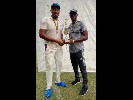 Credit: Contributed Kingston CC’s captain Akim Fraser (left) and coach Terrence Corke with the Senior Cup at the end of the two-day final at Sabina Park yesterday.