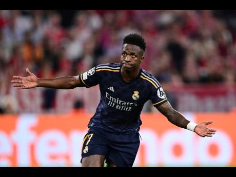 Real Madrid’s Vinícius Júnior celebrates after scoring his side’s second goal on a penalty kick during the Champions League semifinal first-leg football match against Bayern Munich at the Allianz Arena in Munich, Germany yesterday.