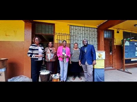 The musical instruments from the ‘Love Changes Lives’ programme were handed over to Haile Selassie High School. From left are Dr Nicholeen DeGrasse Johnson, the arts specialist for the programme; Mylah Jenkinson-Brown and Sharon Powell McLeish of Haile