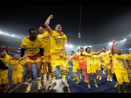 Borussia Dortmund players celebrate at the end of the Champions League semifinal second leg football match between Paris Saint-Germain and Borussia Dortmund at the Parc des Princes stadium in Paris, France, yesterday.