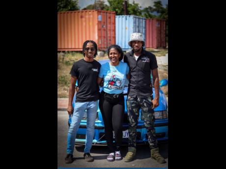 Credit: Organiser of the STGC Day 2024 car show Safarah Danhi (centre), coordinator of People, Brand and Culture posing with Jordan Newman, car enthusiast and old boy, and Marlon Brown (Street Xtream).