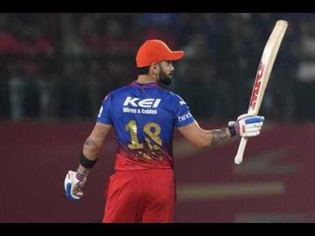 Royal Challengers Bengaluru’s  Virat Kohli  celebrates after reaching his 50 against the Punjab Kings in the Indian Premier League yesterday. 
