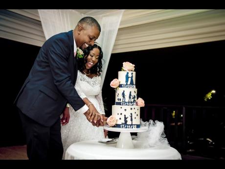 Basking in marital bliss, the newly-weds partake in the traditional cake-cutting ceremony, indulging in this gorgeously tiered dessert made with love by Flour Girl, Asha Atkinson.