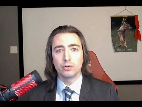 In this image from video provided by the House Financial Services Committee, Keith Gill, a GameStop investor, also known in social media forums as Roaring Kitty, testifies during a virtual hearing on GameStop in Washington, February 18, 2021. The man at th