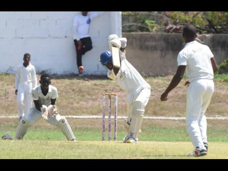 Campion College skipper Adrian Waugh (centre) drives attractively through the covers during his innings of 126 on the first day of their ISSA Urban U16 cricket final against St George’s College at the Kensington Oval yesterday. 