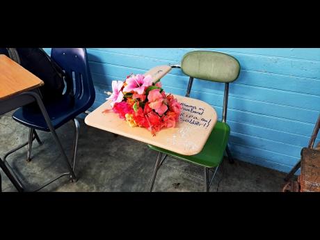Flowers placed on the desk where he would normally sit, serve as a memory for Jajaun Wynter in his grade-nine classroom at Titchfield High School on Wednesday. The school mourned the passing of two students who were killed in a motor vehicle crash on Tuesd