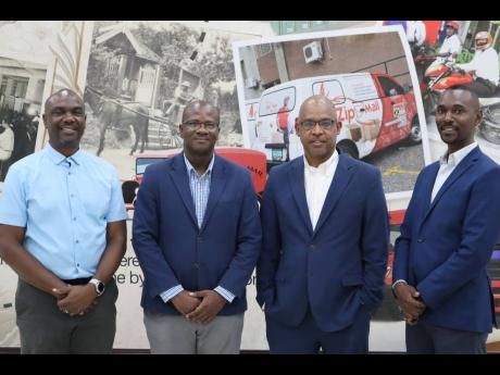 Posing inside the CSO Post Office are (from left) Claude Duncan, country head, Jamaica, and associate vice president, Sutherland Global Services; Kevin McIndoe, senior director, operations, Jamaica Post; Lincoln Allen, postmaster general/CEO, Jamaica Post;