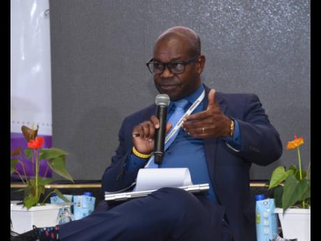 Ansord Hewitt, director general at the Office of Utilities Regulation, speaks during a panel discussion during the second day of the Spectrum Management Authority’s inaugural two-day Caribbean Spectrum Management Conference at the Half Moon Hotel’s Con