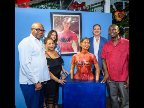 Minister of Tourism, Edmund Bartlett, Sintra  Bronte, her statue sculpted by Scheed Cole (red shirt) share lens time with Kimberly Mais Issa (left back) and Christopher Issa (right back), after the official unveiling at the recently renamed Strings Restaur