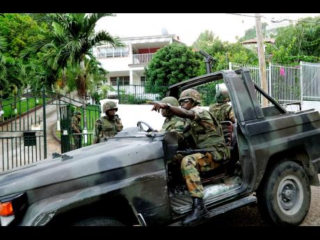 
In this 2010 photo, members of the Jamaica Defence Force and the Jamaica Constabulary Force are seen conducting a raid in Kirkland Avenue. Businessman Keith Clarke was shot and killed by members of the security forces during the first operation, while eig