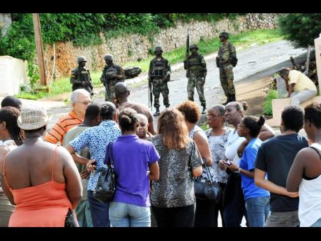 Family and friends of Keith Clarke gather on Kirkland Close where they were barred by soldiers from going to the house in which he was killed by the security forces 
