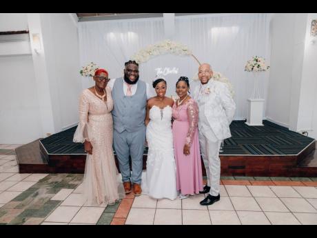 Credit: Joel Photography Surrounded by love, the bride and groom (centre) pose with their parents (from left) Ever Pryce, Julene Martin and Gary Martin.